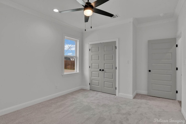 interior space featuring baseboards, ornamental molding, and carpet