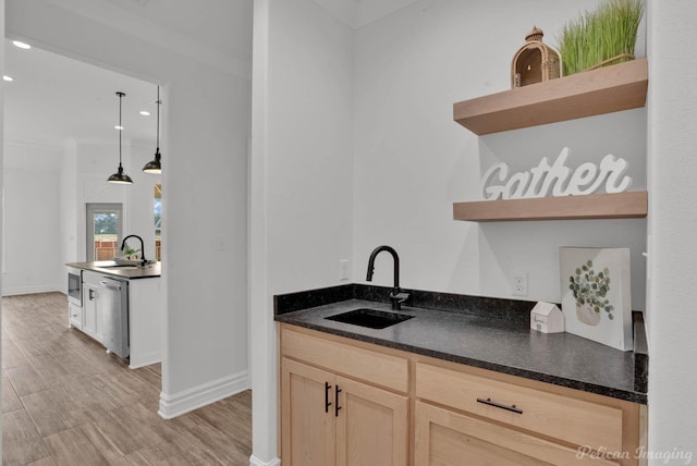 bar with stainless steel dishwasher, baseboards, a sink, and light wood-style flooring