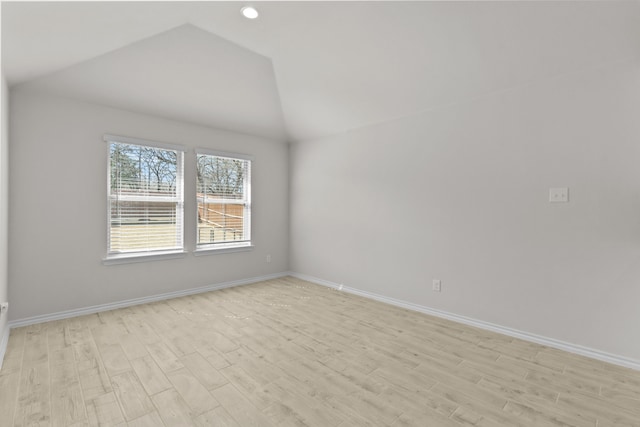 unfurnished room with recessed lighting, baseboards, vaulted ceiling, and light wood finished floors