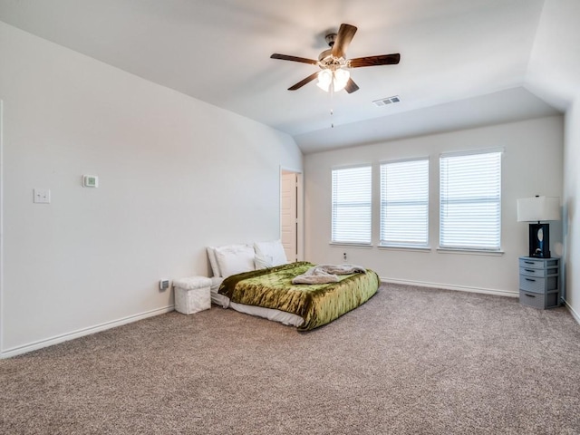 bedroom with lofted ceiling, baseboards, visible vents, and carpet flooring