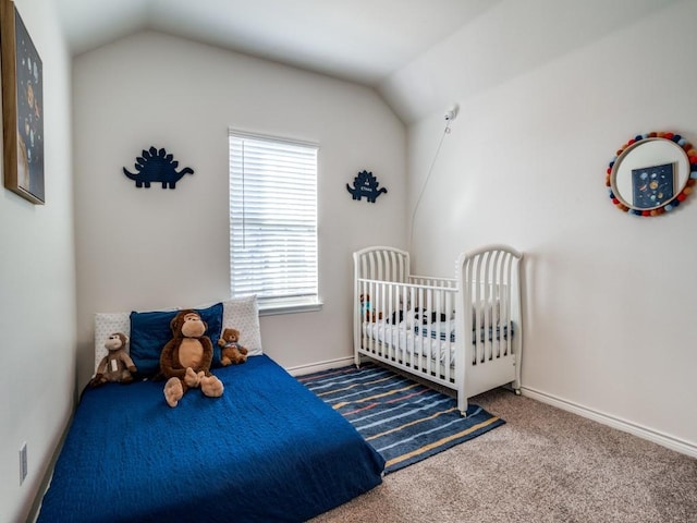 carpeted bedroom with baseboards and vaulted ceiling