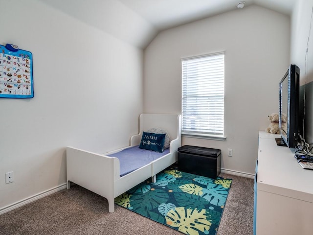 carpeted bedroom featuring baseboards and vaulted ceiling