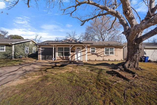 ranch-style house with a garage, concrete driveway, and a front yard