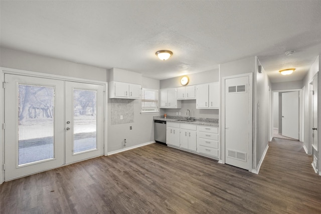 kitchen with dishwasher, visible vents, and white cabinetry