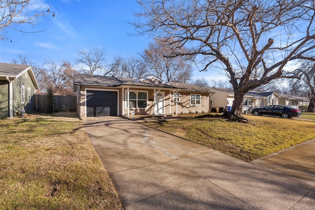 view of front of property featuring a front lawn, concrete driveway, fence, and an attached garage