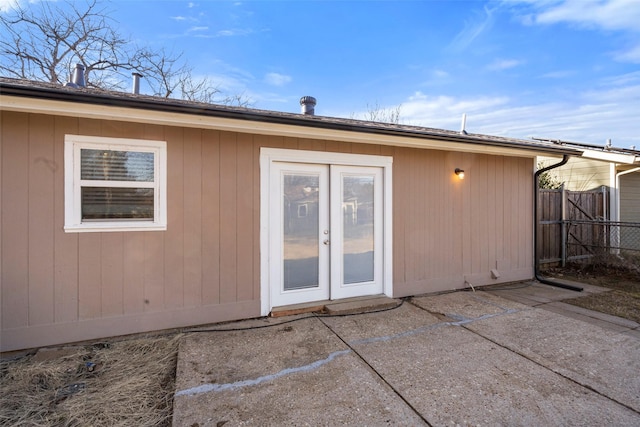 rear view of property with a patio, french doors, and fence