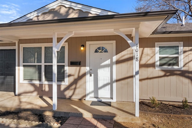 view of exterior entry with covered porch