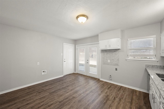 kitchen featuring plenty of natural light, dark wood-type flooring, and french doors