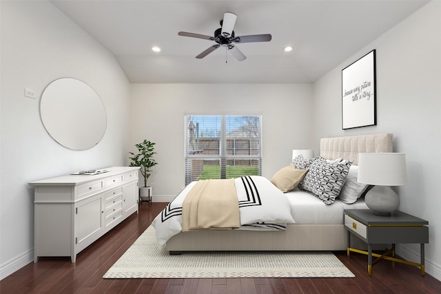 bedroom with dark wood-style floors, vaulted ceiling, recessed lighting, and baseboards