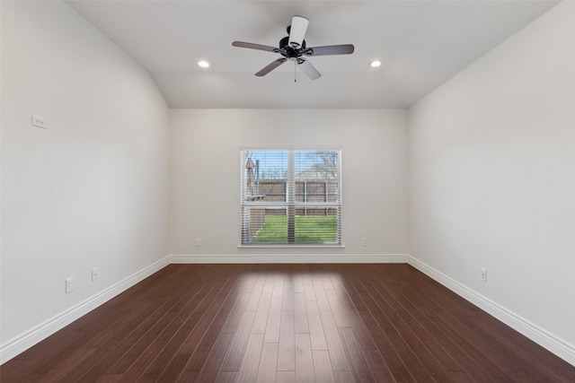 unfurnished room with lofted ceiling, dark wood-style flooring, baseboards, and recessed lighting