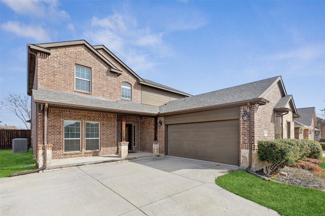 traditional-style home featuring driveway, roof with shingles, an attached garage, central AC, and brick siding