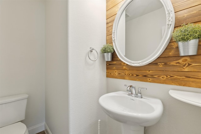 half bathroom with a sink and toilet