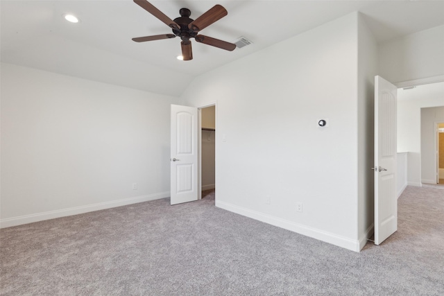 unfurnished bedroom featuring baseboards, visible vents, lofted ceiling, carpet floors, and recessed lighting