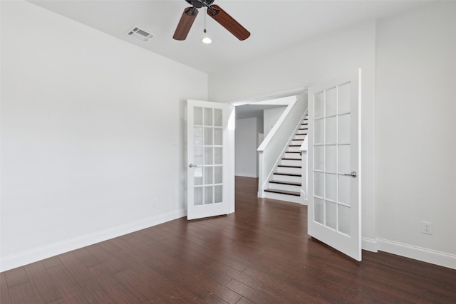 spare room featuring french doors, visible vents, baseboards, and wood finished floors