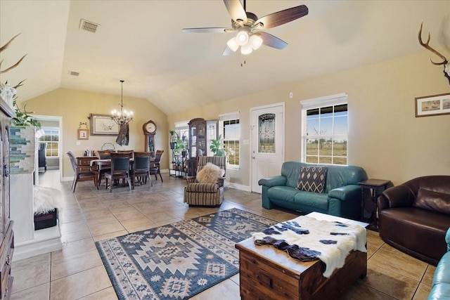 living room featuring lofted ceiling, visible vents, and a wealth of natural light