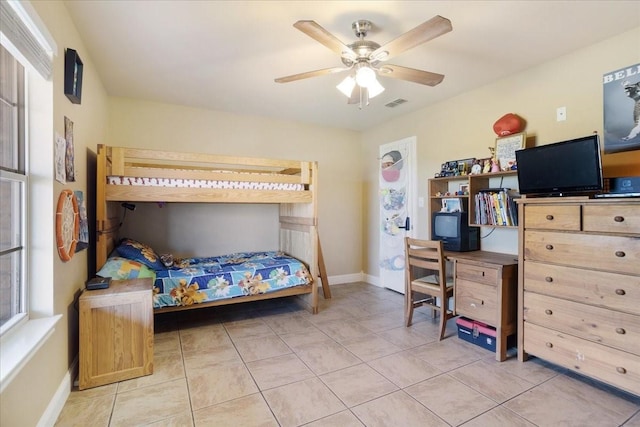 bedroom featuring light tile patterned floors, baseboards, visible vents, and a ceiling fan