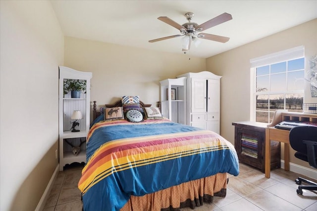 bedroom with light tile patterned floors, baseboards, and a ceiling fan