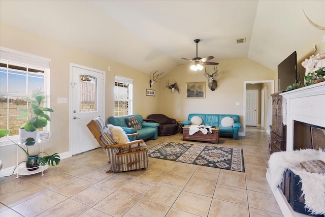 living room with a fireplace, light tile patterned floors, lofted ceiling, visible vents, and a ceiling fan