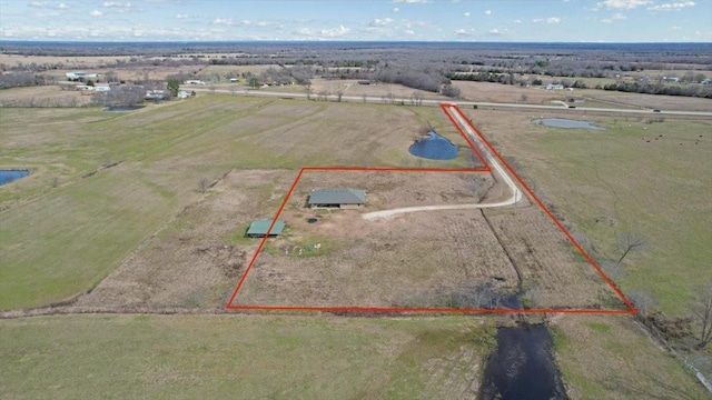 birds eye view of property featuring a rural view