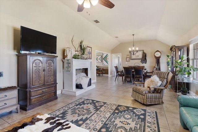 living room featuring visible vents, vaulted ceiling, a fireplace, and light tile patterned flooring