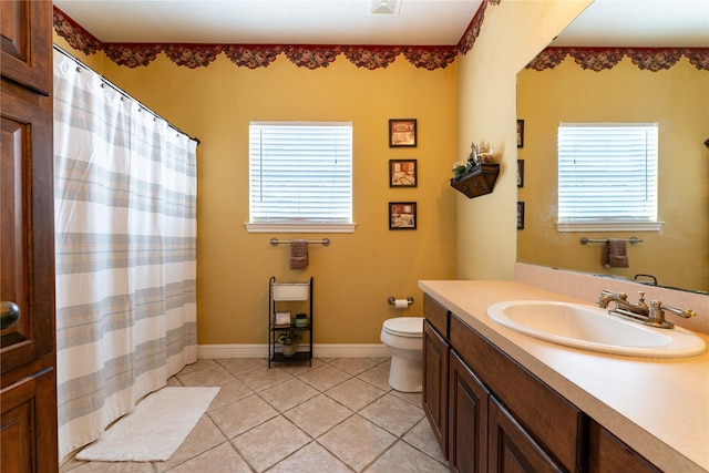 3630 Darnell Dr, Paris, TX 75462 - bathroom with plenty of natural light, toilet, tile patterned floors, and vanity