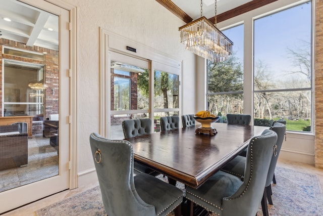 dining space featuring beam ceiling, coffered ceiling, a chandelier, and a textured wall