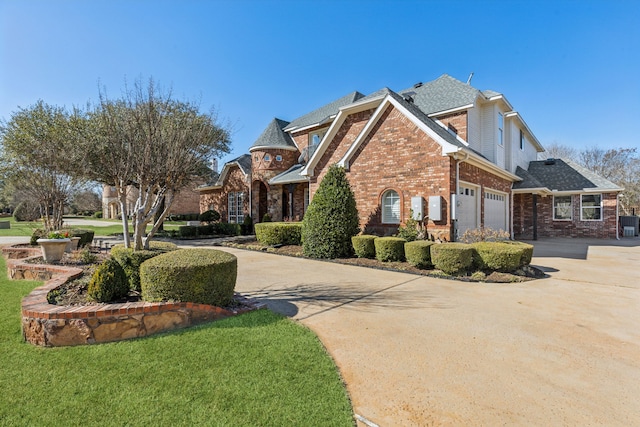 exterior space with brick siding, driveway, and a front lawn