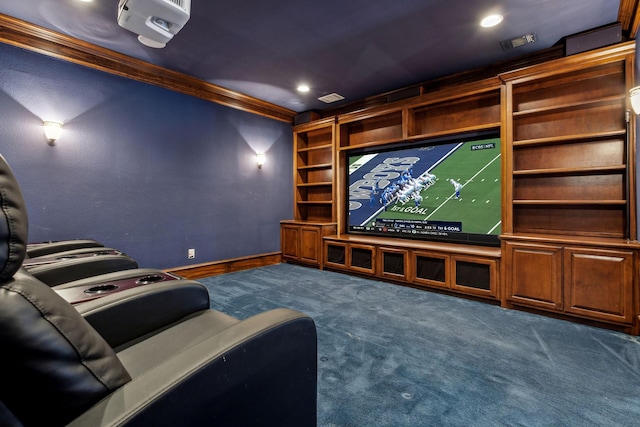 home theater with dark colored carpet, visible vents, baseboards, and ornamental molding