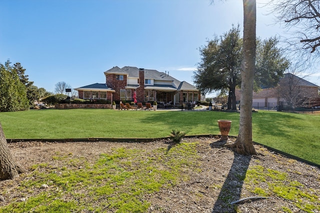 exterior space with a lawn, brick siding, and a patio area