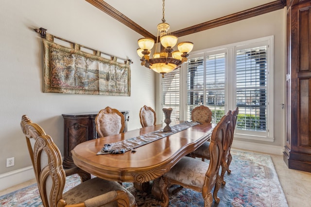 dining room featuring a chandelier, baseboards, and ornamental molding