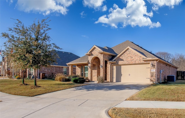 view of front of property featuring brick siding, roof with shingles, a garage, driveway, and a front lawn