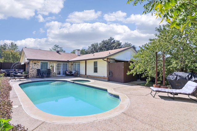 view of swimming pool with an in ground hot tub, a patio, and a grill