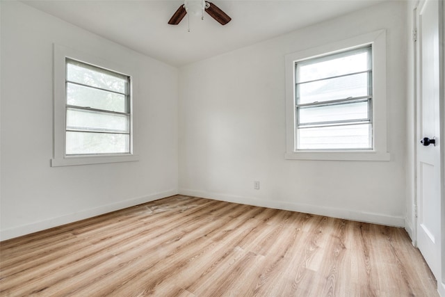 unfurnished room with light wood finished floors, baseboards, and a ceiling fan