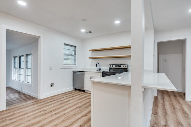 kitchen featuring light wood finished floors, visible vents, dishwasher, open shelves, and range with electric stovetop