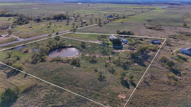 birds eye view of property featuring a rural view and a water view