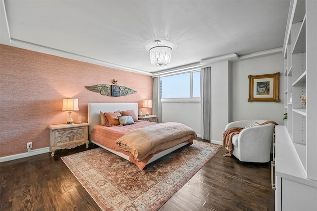 bedroom featuring dark wood-style floors, wallpapered walls, a chandelier, and baseboards