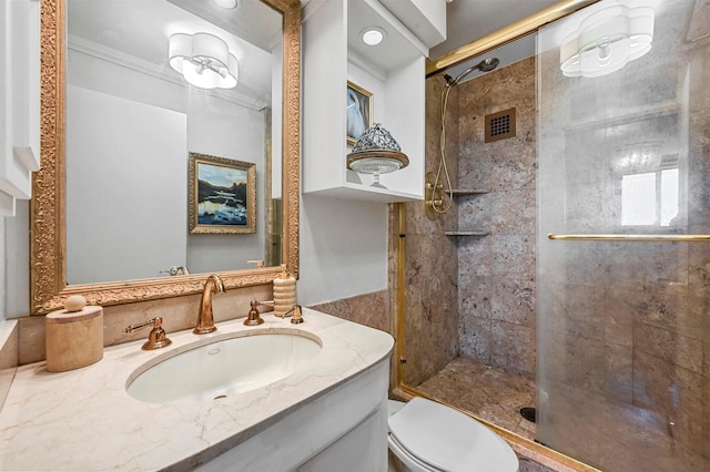 bathroom featuring vanity, a shower stall, toilet, and crown molding