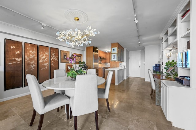 dining space with an inviting chandelier and track lighting