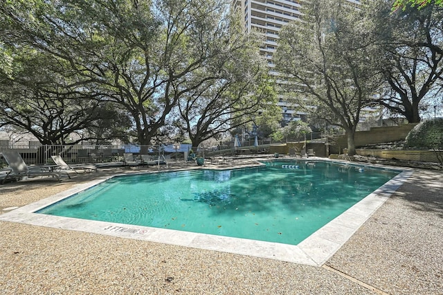 pool featuring fence and a patio