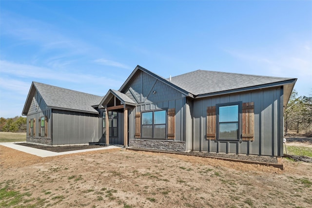 view of front of house with board and batten siding and a shingled roof