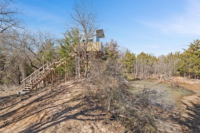 view of landscape featuring a forest view