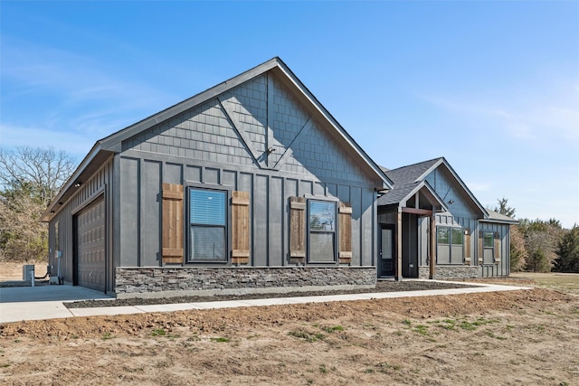 view of front of home featuring a garage, board and batten siding, and driveway