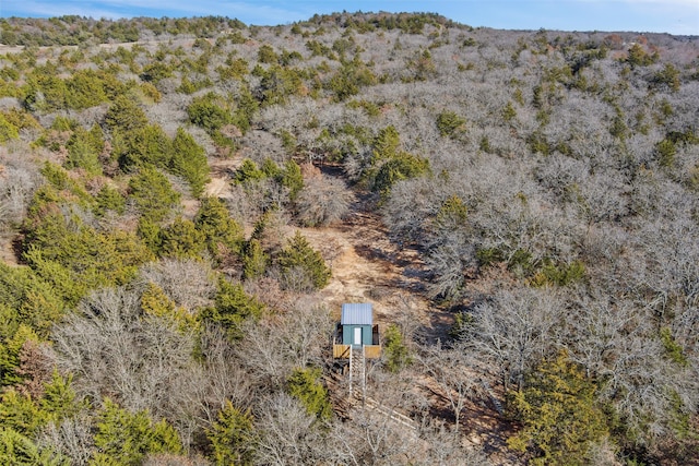 drone / aerial view featuring a mountain view and a wooded view