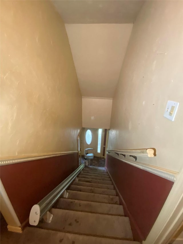 stairs with lofted ceiling