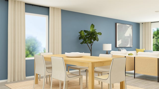 dining room with a wealth of natural light, light wood-style flooring, and baseboards