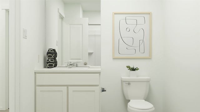 bathroom featuring toilet and vanity