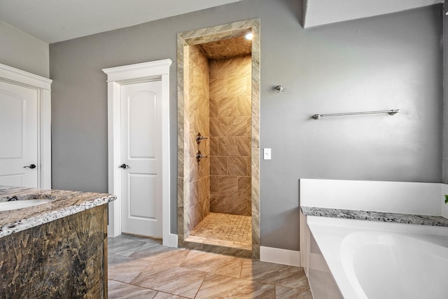 full bathroom with a garden tub, baseboards, a tile shower, and vanity