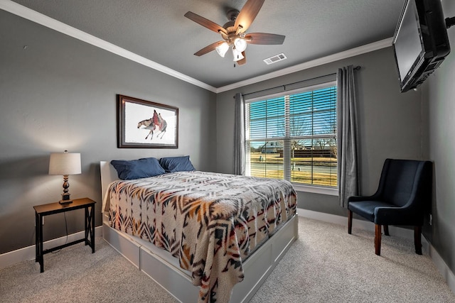 bedroom with baseboards, a textured ceiling, visible vents, and crown molding