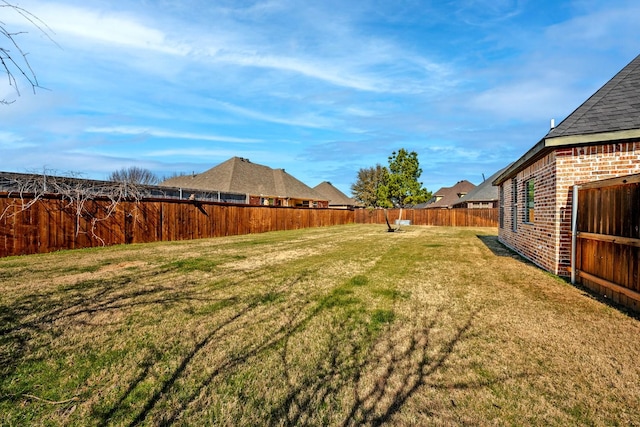 view of yard with a fenced backyard