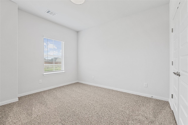 unfurnished room with baseboards, visible vents, and carpet flooring